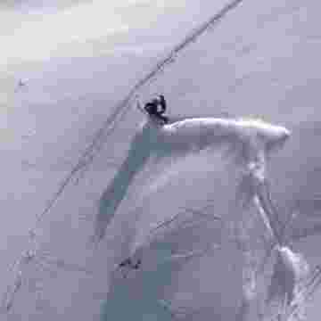 Motoneigiste s'aventurant sur une dangereuse pente